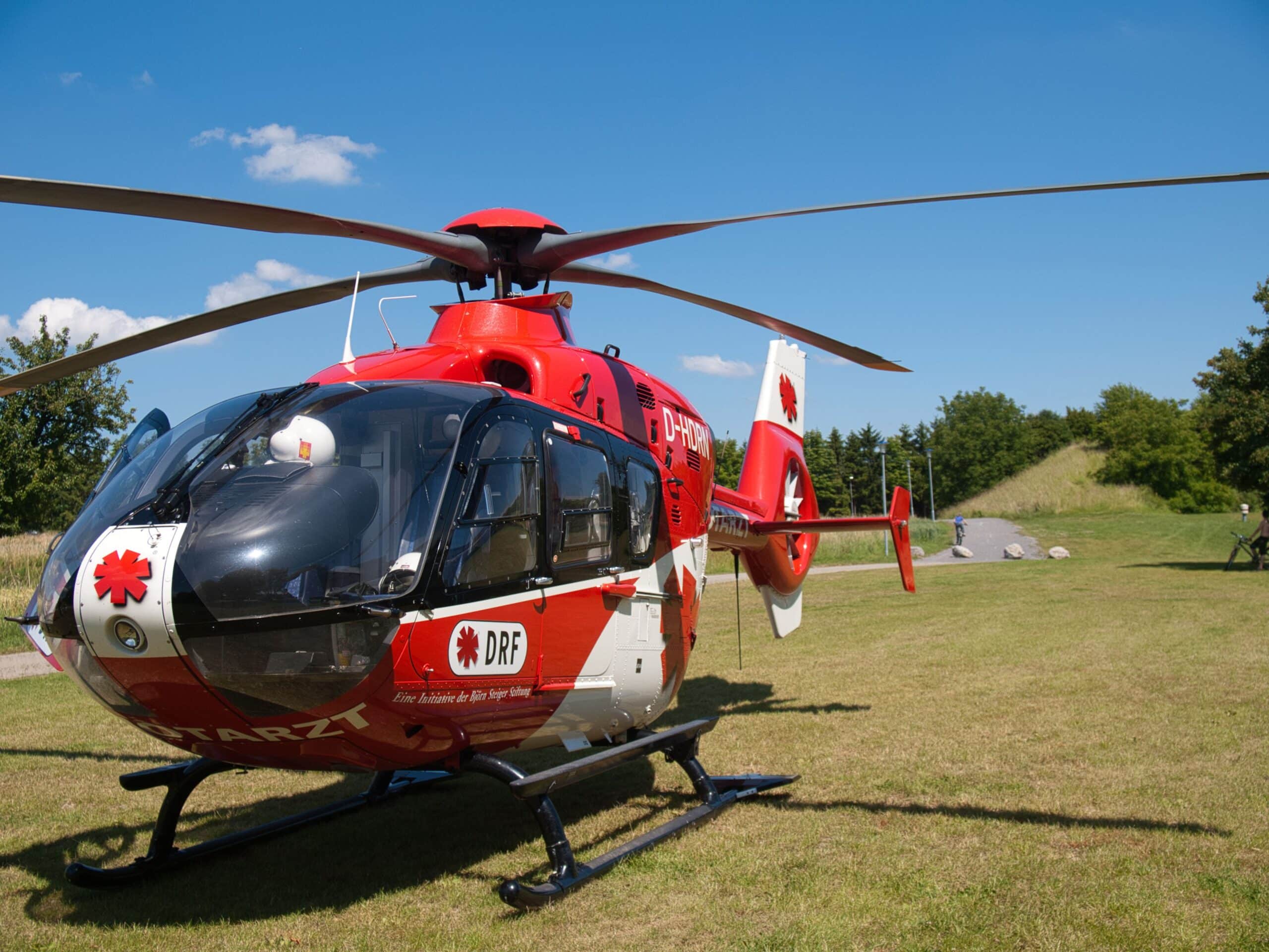 Red air ambulance helicopter on a landing field