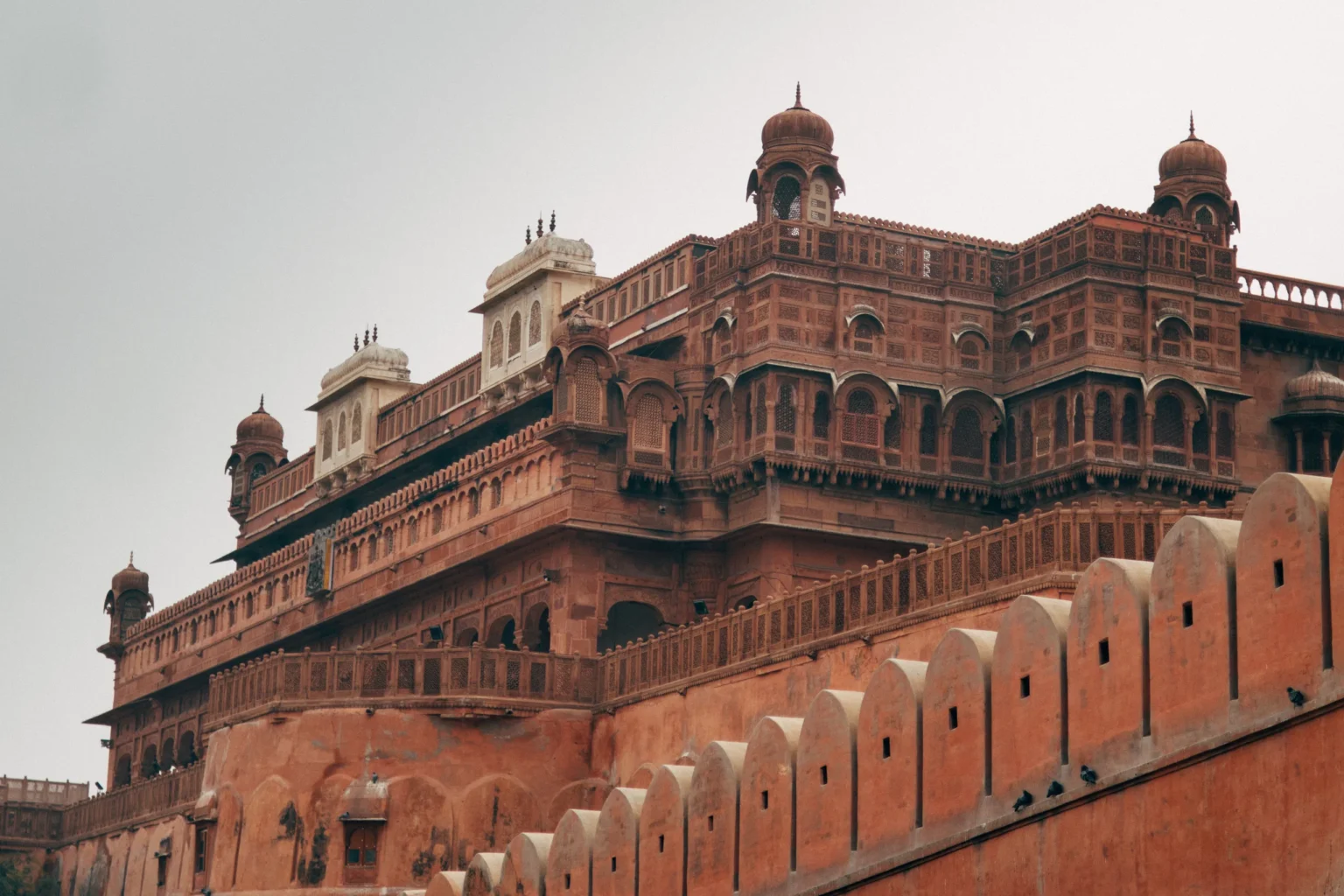 Red sandstone palace of Junagarh Fort above its crenellated wall