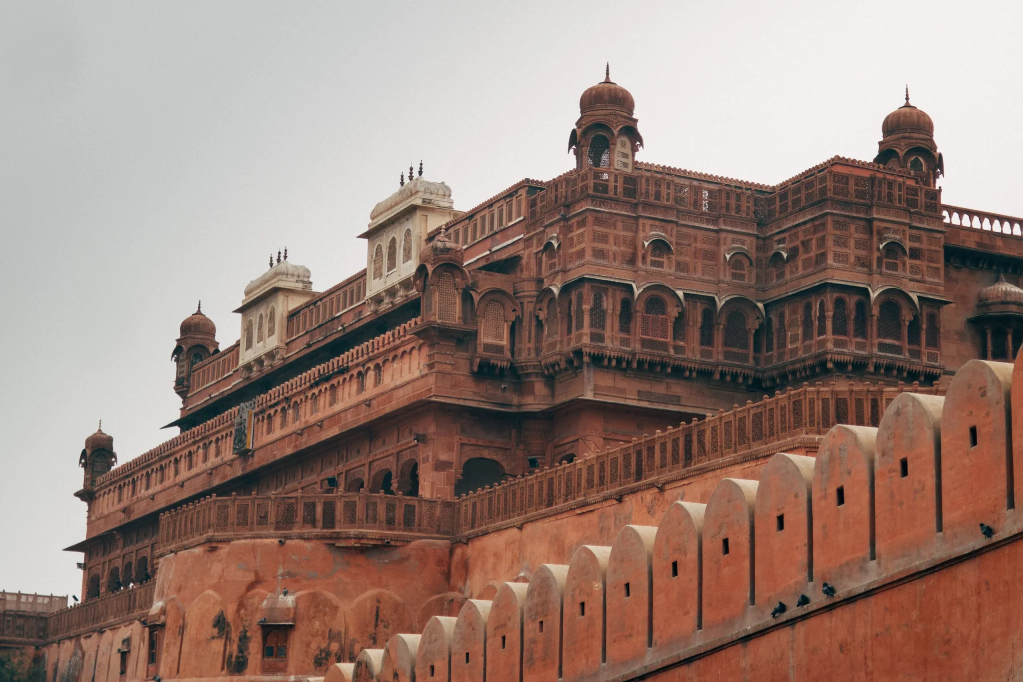Red sandstone palace of Junagarh Fort above its crenellated wall