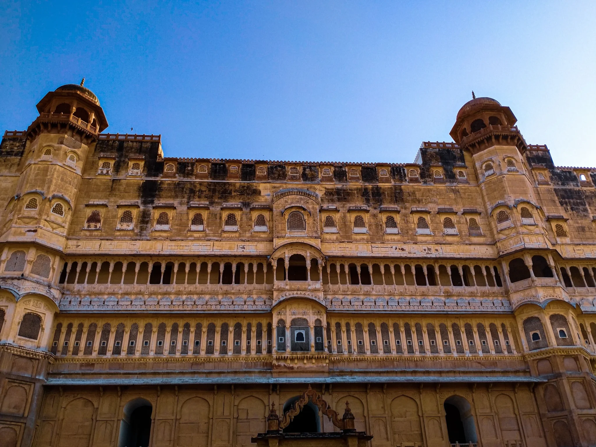 Ornate Junagarh Fort facade in Bikaner against a blue sky