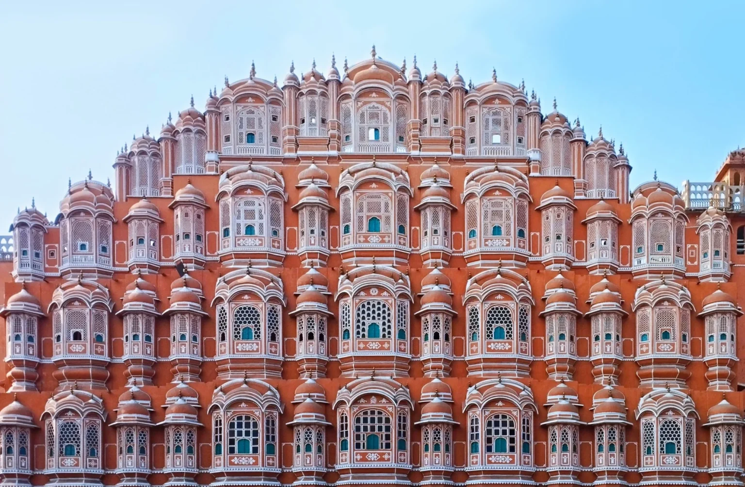 Symmetrical pink facade of Hawa Mahal with its many small windows