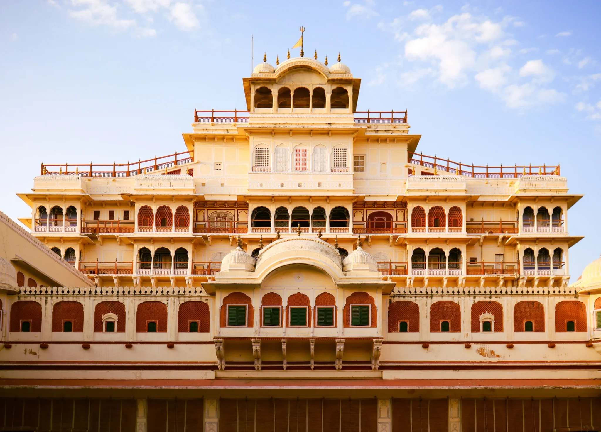Chandra Mahal of Jaipur's City Palace under a blue sky with clouds