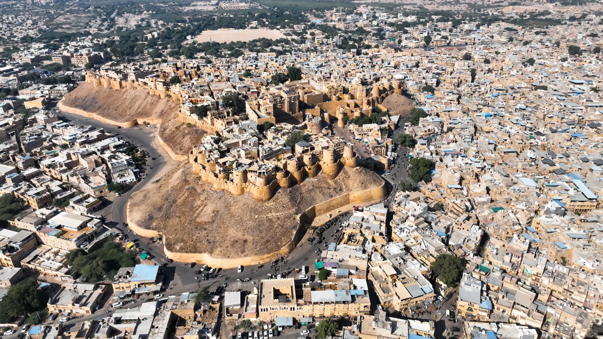 Aerial view of golden Jaisalmer Fort on its hill amid the old city