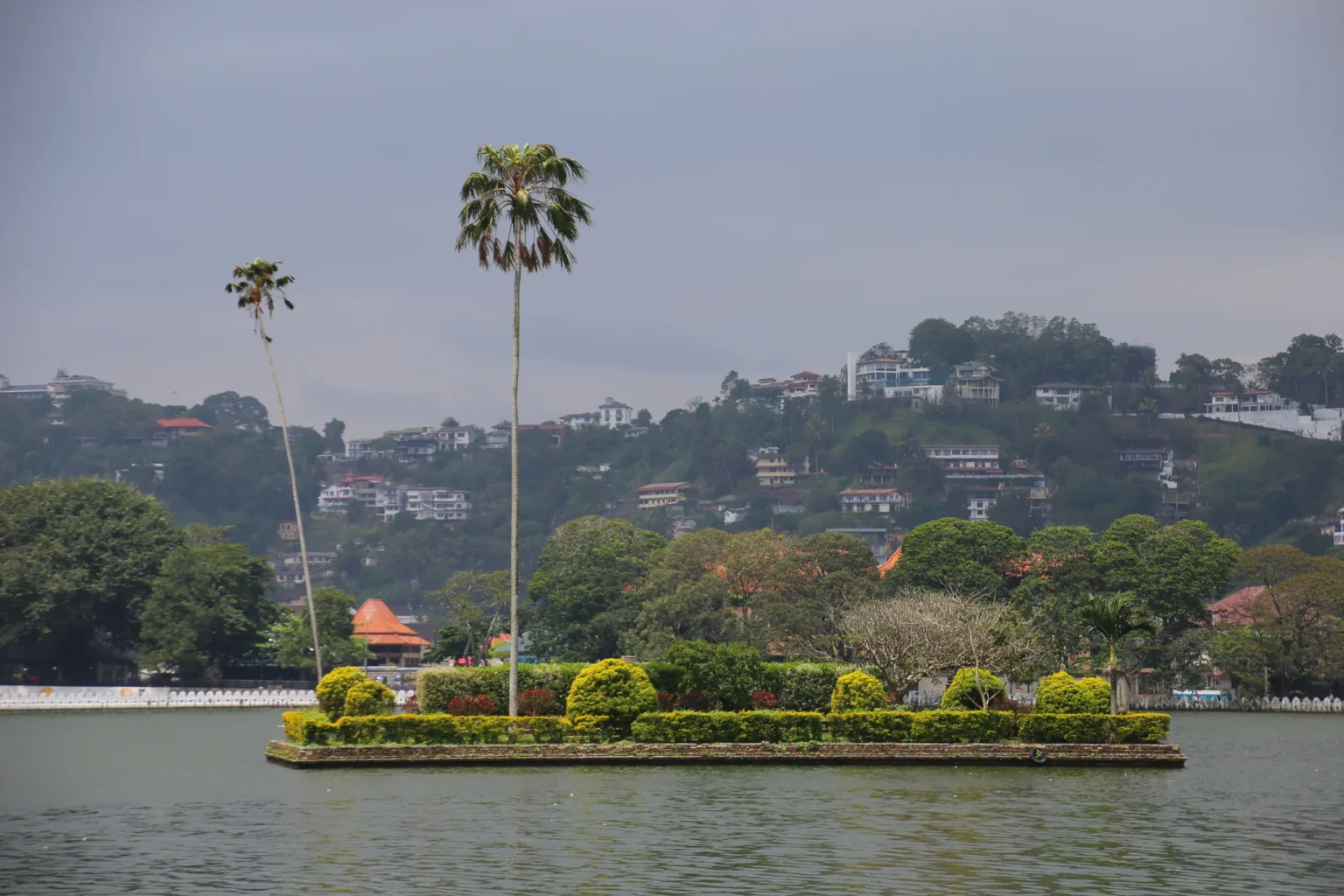 Diyathilaka Mandapa island on Kandy Lake with the town behind