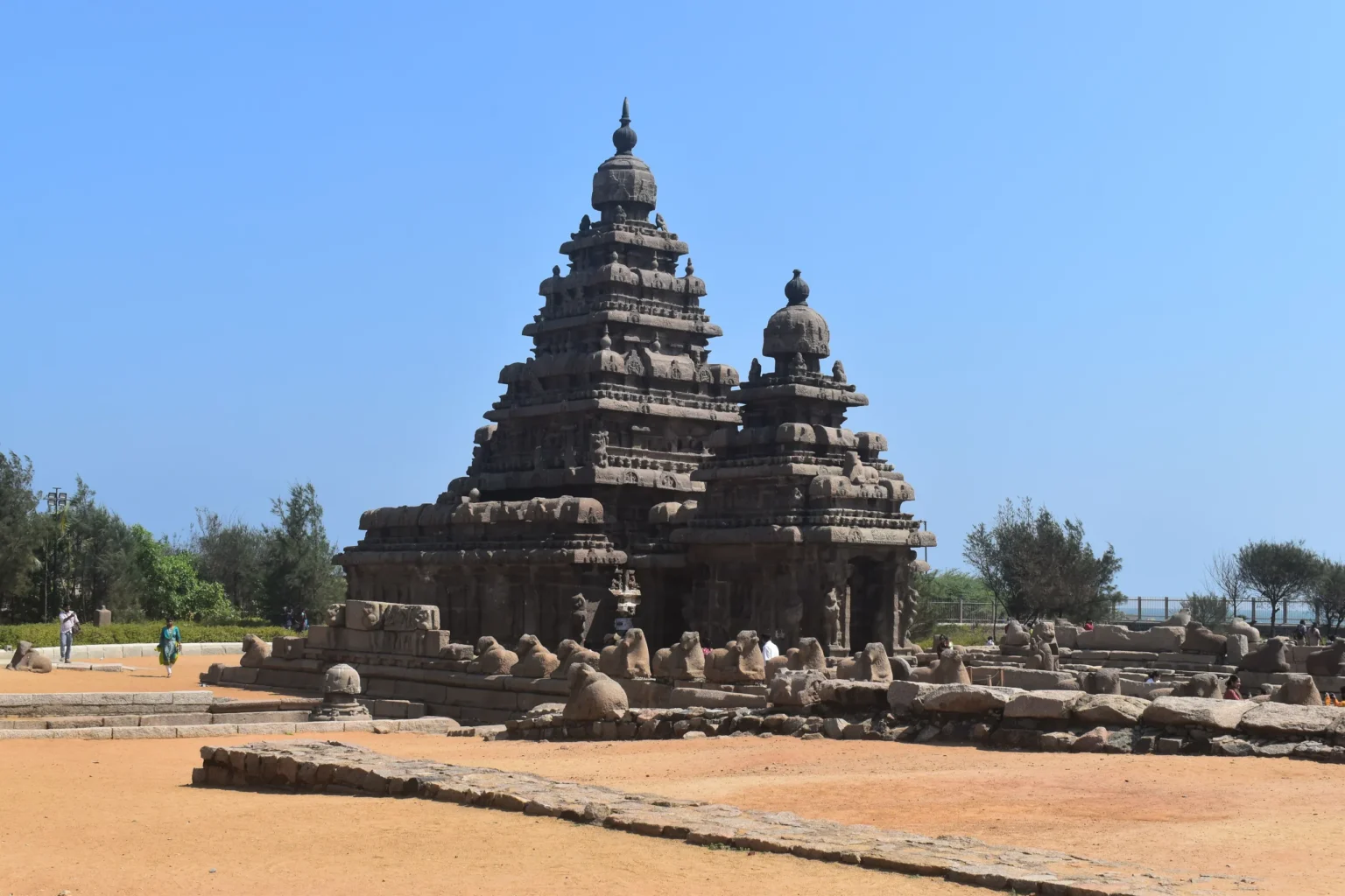 Shore Temple at Mahabalipuram with its Nandi-lined enclosure, blue sky