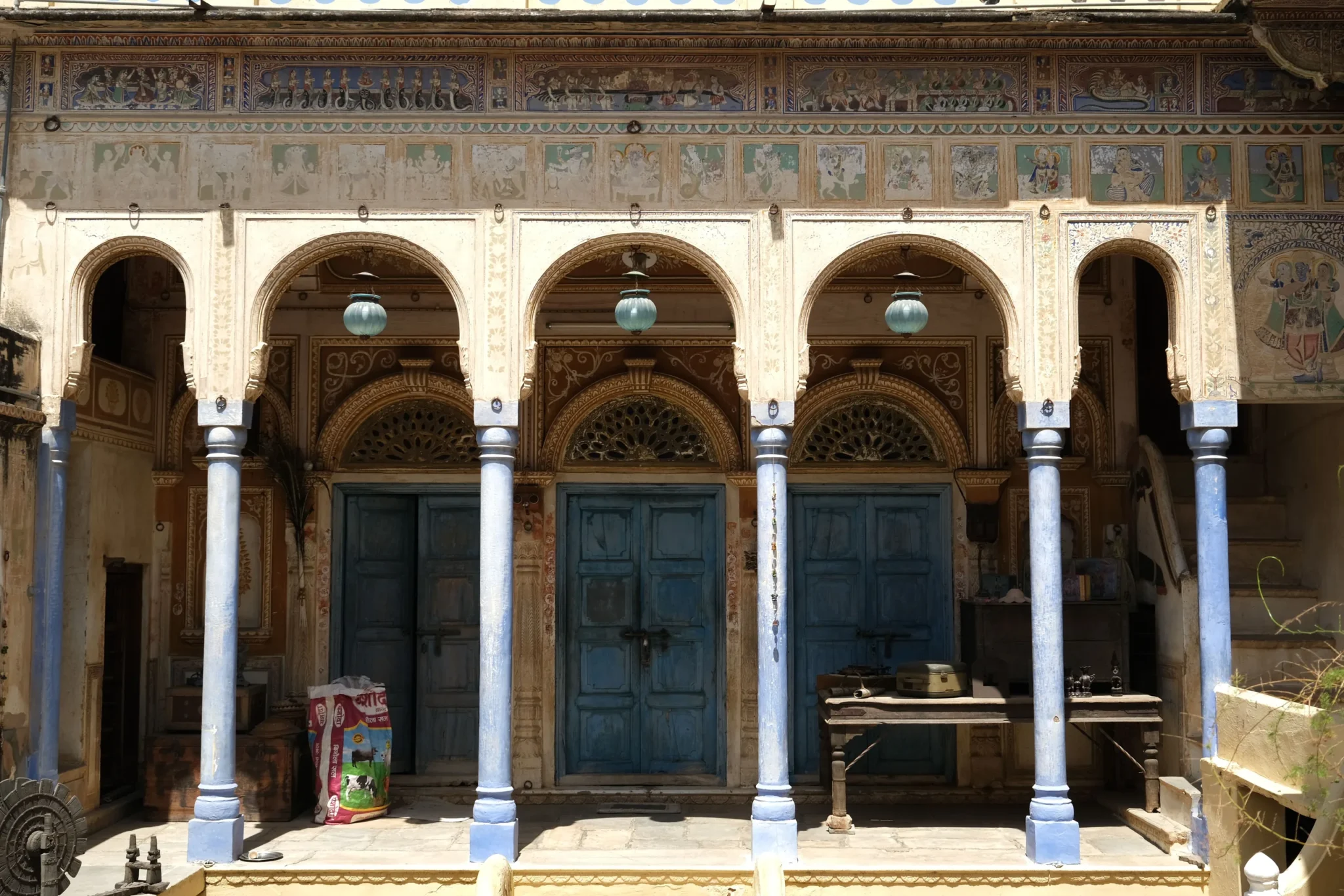 Painted haveli arcade in Mandawa with frescoes and blue doors