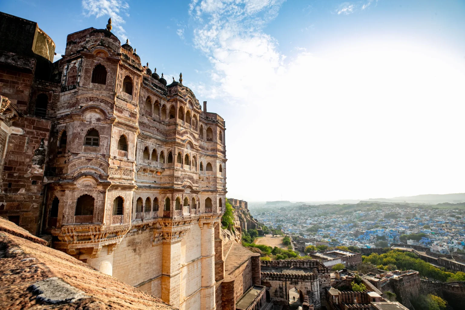 Carved Mehrangarh palace facade above the blue houses of Jodhpur