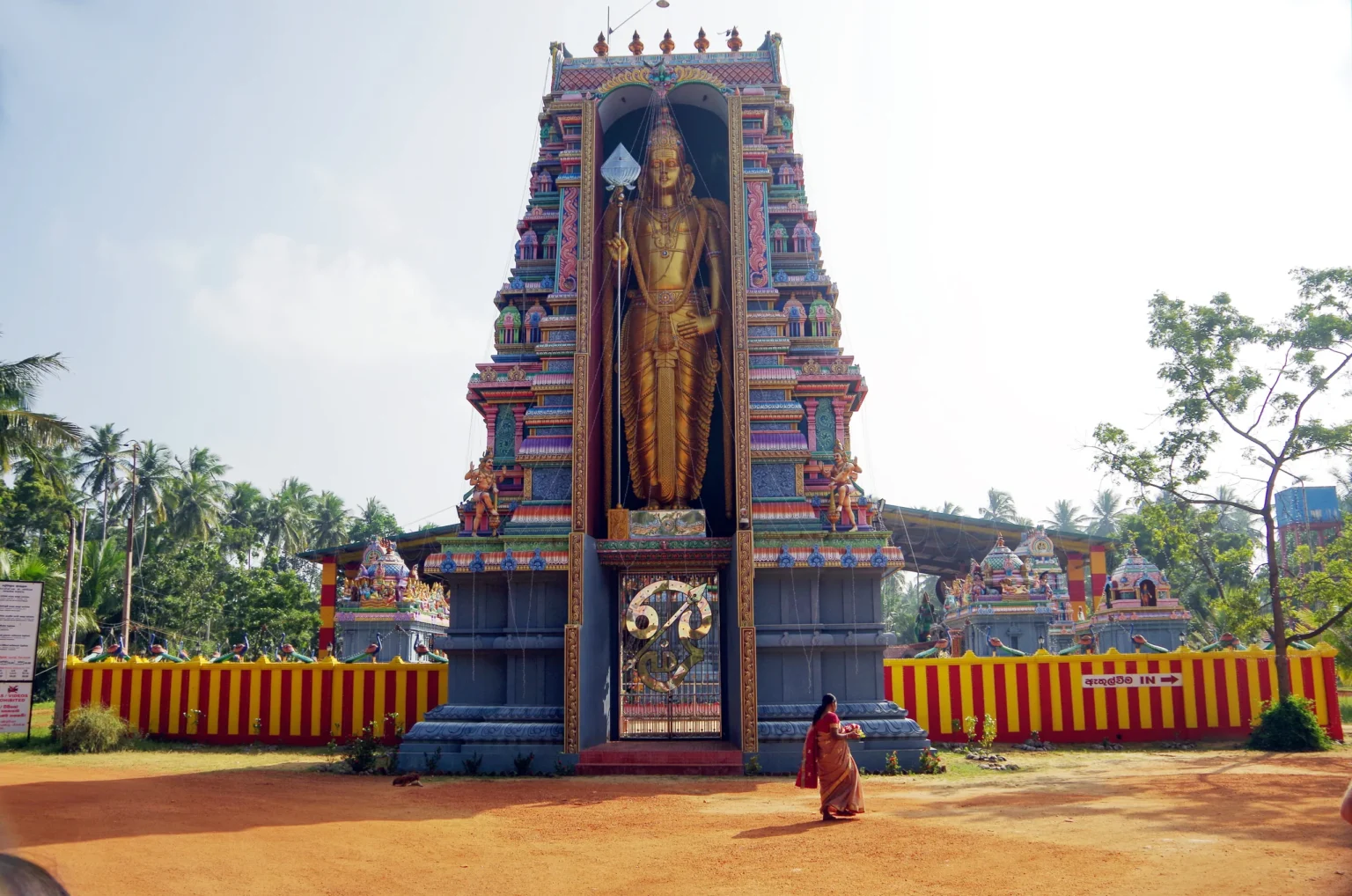 Painted Hindu temple tower with a standing deity at Munneswaram, Chilaw