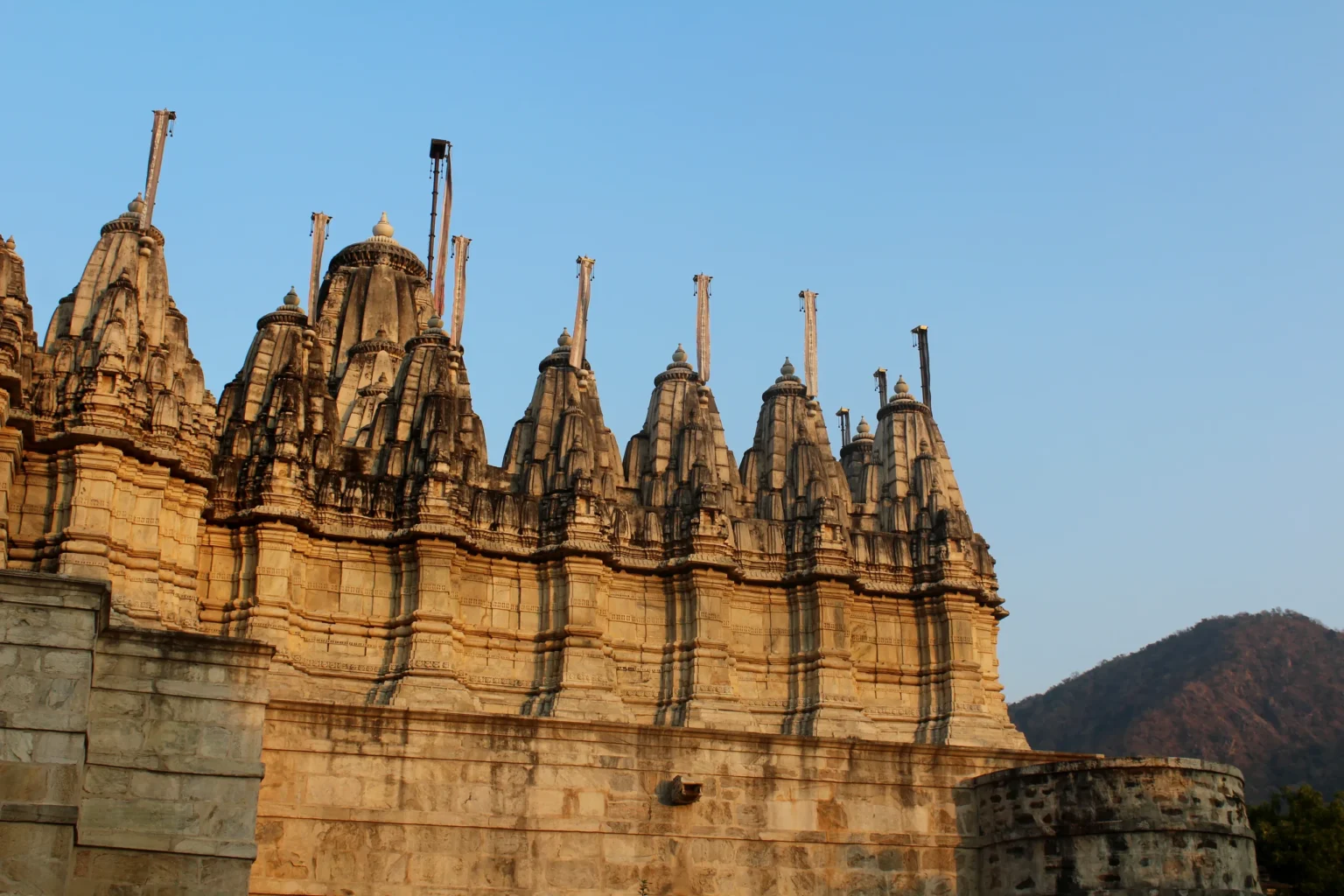 Carved stone spires of the Ranakpur Jain Temple against a blue sky