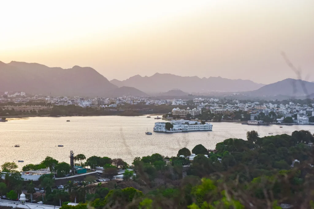 Lake Pichola at sunset with the Lake Palace and Aravalli hills beyond